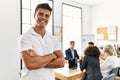 Young hispanic businessman smiling happy standing with arms crossed gesture at the office during business meeting Royalty Free Stock Photo