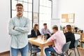 Young hispanic businessman smiling happy standing with arms crossed gesture at the office during business meeting Royalty Free Stock Photo