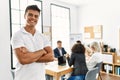Young hispanic businessman smiling happy standing with arms crossed gesture at the office during business meeting Royalty Free Stock Photo