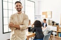 Young hispanic businessman smiling happy standing with arms crossed gesture at the office during business meeting Royalty Free Stock Photo