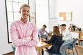 Young hispanic businessman smiling happy standing with arms crossed gesture at the office during business meeting Royalty Free Stock Photo