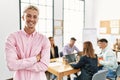 Young hispanic businessman smiling happy standing with arms crossed gesture at the office during business meeting Royalty Free Stock Photo