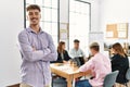 Young hispanic businessman smiling happy standing with arms crossed gesture at the office during business meeting Royalty Free Stock Photo