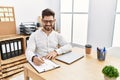 Young hispanic businessman smiling happy working at the office Royalty Free Stock Photo