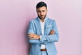Young hispanic businessman wearing business jacket skeptic and nervous, disapproving expression on face with crossed arms Royalty Free Stock Photo