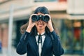 Young hispanic businesswoman looking for new opportunity using binoculars at the city Royalty Free Stock Photo