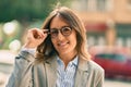 Young hispanic businesswoman smiling happy touching her glasses at the city Royalty Free Stock Photo