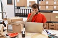 Young hispanic call center agent man working at warehouse tired rubbing nose and eyes feeling fatigue and headache Royalty Free Stock Photo