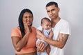 Young hispanic couple with baby standing together over isolated background touching mouth with hand with painful expression Royalty Free Stock Photo