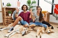 Young hispanic couple doing laundry with dogs relaxed and smiling with eyes closed doing meditation gesture with fingers