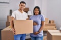 Young hispanic couple expecting a baby moving to a new home smiling with a happy and cool smile on face Royalty Free Stock Photo