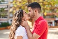 Young hispanic couple smiling confident hugging each other and kissing at park Royalty Free Stock Photo