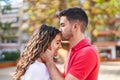 Young hispanic couple smiling confident hugging each other and kissing at park Royalty Free Stock Photo