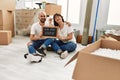 Young hispanic couple smiling happy holding our new home blackboard and key at new home Royalty Free Stock Photo