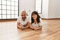 Young hispanic couple smiling happy lying on the floor at empty new home Royalty Free Stock Photo