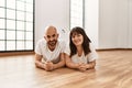 Young hispanic couple smiling happy lying on the floor at empty new home Royalty Free Stock Photo