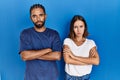 Young hispanic couple standing together skeptic and nervous, disapproving expression on face with crossed arms Royalty Free Stock Photo