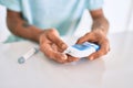 Young hispanic diabetic man measuring glucose level at home