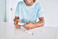 Young hispanic diabetic man smiling happy measuring glucose level at home