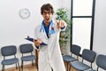 Young hispanic doctor man at waiting room pointing displeased and frustrated to the camera, angry and furious with you Royalty Free Stock Photo