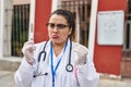 Young hispanic doctor woman doing coronavirus infection nasal test depressed and worry for distress, crying angry and afraid