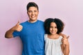 Young hispanic family of brother and sister wearing casual clothes together doing happy thumbs up gesture with hand Royalty Free Stock Photo