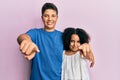 Young hispanic family of brother and sister wearing casual clothes together pointing to you and the camera with fingers, smiling Royalty Free Stock Photo