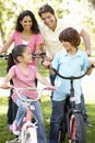 Young Hispanic Family Cycling In Park Royalty Free Stock Photo