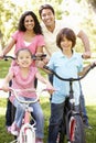 Young Hispanic Family Cycling In Park Royalty Free Stock Photo