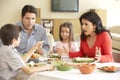 Young Hispanic Family Enjoying Meal At Home Royalty Free Stock Photo