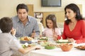 Young Hispanic Family Enjoying Meal At Home Royalty Free Stock Photo