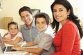 Young Hispanic Family Using Computer At Home Royalty Free Stock Photo