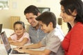 Young Hispanic Family Using Computer At Home Royalty Free Stock Photo