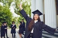 Young hispanic female graduate background of graduates at the university
