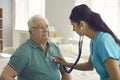 Young hispanic female nurse check mature caucasian man patient heartbeat closeup