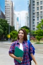 Young hispanic female student in city