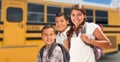 Young Hispanic Girl and Boys Walking Near School Bus