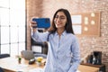 Young hispanic girl business worker make selfie by smartphone at office Royalty Free Stock Photo