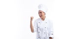 Young hispanic girl in cook uniform very happy and excited making winner gesture with arm raised, smiling and shouting for success Royalty Free Stock Photo