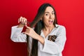 Young hispanic girl cutting hair using scissors celebrating crazy and amazed for success with open eyes screaming excited Royalty Free Stock Photo