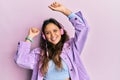 Young hispanic girl dancing and listening to music using headphones smiling with a happy and cool smile on face Royalty Free Stock Photo