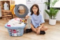 Young hispanic girl doing laundry holding socks making fish face with lips, crazy and comical gesture Royalty Free Stock Photo