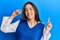 Young hispanic girl holding cpu computer processor smiling happy pointing with hand and finger to the side Royalty Free Stock Photo