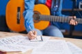 Young hispanic girl musician composing song playing classical guitar at music studio Royalty Free Stock Photo