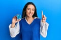 Young hispanic girl playing colorful puzzle cube intelligence game smiling with an idea or question pointing finger with happy Royalty Free Stock Photo