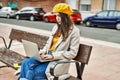 Young hispanic girl with serious expression working using laptop at the city Royalty Free Stock Photo