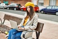 Young hispanic girl with serious expression working using laptop at the city Royalty Free Stock Photo