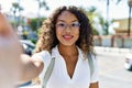 Young hispanic girl smiling happy making selfie by the camera at the city Royalty Free Stock Photo