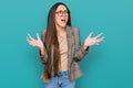 Young hispanic girl wearing business clothes and glasses crazy and mad shouting and yelling with aggressive expression and arms Royalty Free Stock Photo