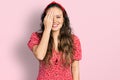 Young hispanic girl wearing casual clothes covering one eye with hand, confident smile on face and surprise emotion Royalty Free Stock Photo